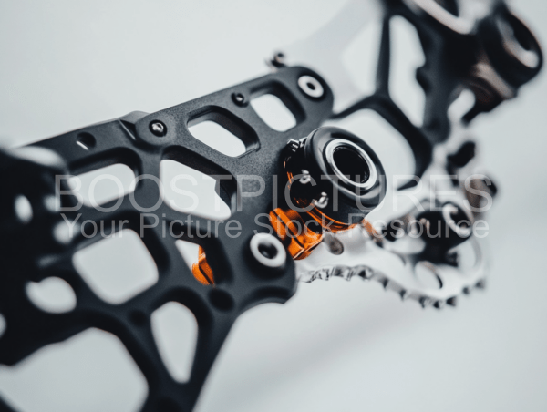 A close-up of a complex mechanical part with a black and orange color scheme