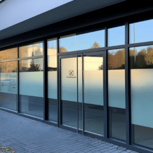 A modern, minimalist storefront with large glass windows.